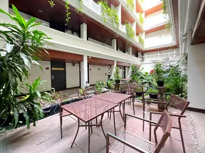a patio with a table and chairs and plants at Arawana Regency Park Sukhumvit in Bangkok