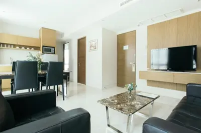 a living room with a couch and a table at Thomson Residence Hotel in Bangkok