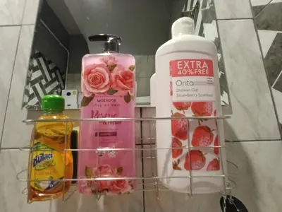 a shelf with a bottle of soap and other items at My Home N1 - BTS Ratchathewi in Bangkok