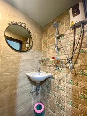 a bathroom with a sink and a mirror at 4J Lodge in Bangkok