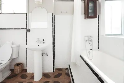 a white bathroom with a sink and a tub and a toilet at Ob-Oon Boutique Bed & Breakfast in Bangkok