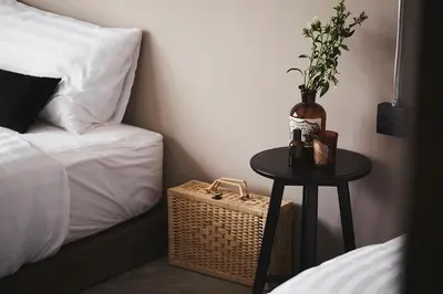 a table with a vase on it next to a bed at Ob-Oon Boutique Bed & Breakfast in Bangkok