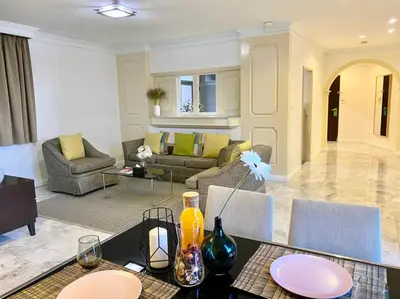 a living room with a table and a couch at Asoke Residence Sukhumvit by UHG in Bangkok