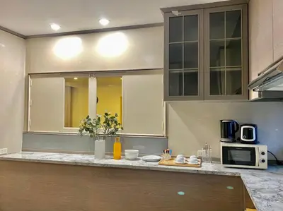 a kitchen with a counter top with a microwave at Asoke Residence Sukhumvit by UHG in Bangkok