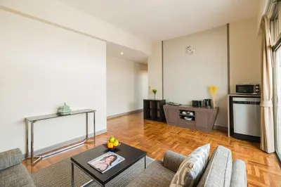 a living room with a couch and a table at Asoke Residence Sukhumvit by UHG in Bangkok