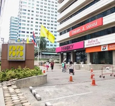 a group of people walking in front of a building at Asoke Residence Sukhumvit by UHG in Bangkok