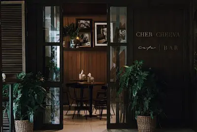 a restaurant with a table and chairs and plants at Siam Nitra Boutique Hotel in Bangkok