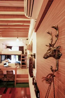 a mounted deer head on a wall in a room at Siam Nitra Boutique Hotel in Bangkok