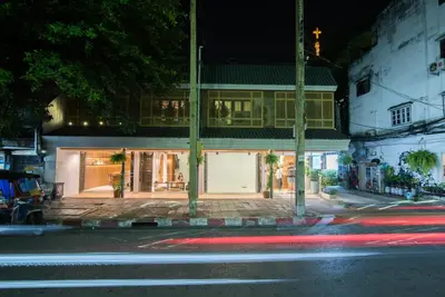 a building on the side of a street at night at Siam Nitra Boutique Hotel in Bangkok