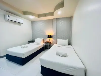 a room with two beds and a lamp in it at Bed by Tha-Pra SHA Plus in Bangkok