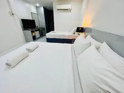 a hotel room with two beds with white pillows at Bed by Tha-Pra SHA Plus in Bangkok