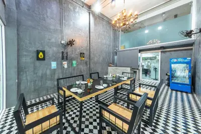 a dining room with a table and chairs at Bed by Tha-Pra SHA Plus in Bangkok