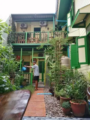 a young boy standing in front of a building at Baan Tepa Boutique House in Bangkok