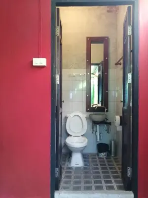a bathroom with a toilet and a sink at Baan Tepa Boutique House in Bangkok