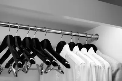 a rack of black knives and white clothes at Apartelle Jatujak Hotel in Bangkok