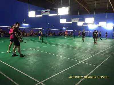 a group of people playing tennis on a tennis court at Tuk Tuk Hostel in Bangkok