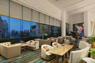 a restaurant with tables and chairs and large windows at The Westin Grande Sukhumvit, Bangkok in Bangkok