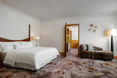 a bedroom with a large white bed and a couch at The Westin Grande Sukhumvit, Bangkok in Bangkok