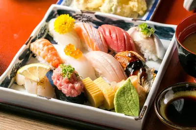 a tray of sushi and vegetables on a table at The Westin Grande Sukhumvit, Bangkok in Bangkok