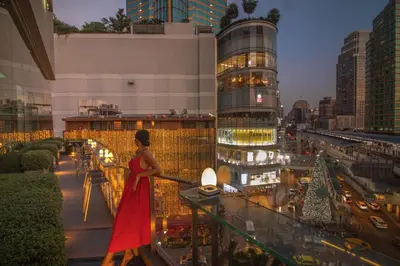 a woman in a red dress standing on a balcony at The Westin Grande Sukhumvit, Bangkok in Bangkok
