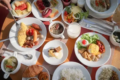 a table with many plates of food on it at Aloft Bangkok - Sukhumvit 11 in Bangkok