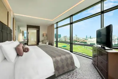 a bedroom with a large bed and a large window at The St. Regis Bangkok in Bangkok