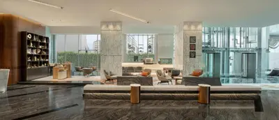 a lobby with a couch and chairs in a building at Le Meridien Bangkok in Bangkok