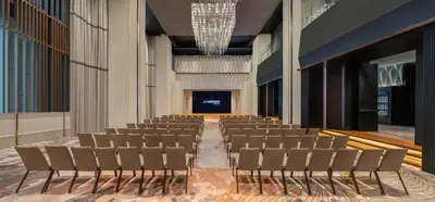 an empty lecture hall with chairs and a stage at Le Meridien Bangkok in Bangkok