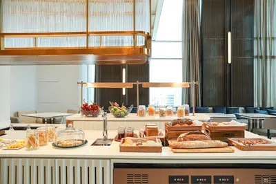 a buffet of food on a table in a restaurant at Le Meridien Bangkok in Bangkok