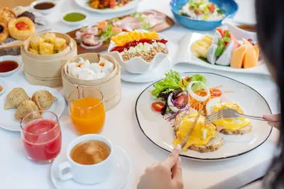 a table filled with plates of food and drinks at Paradox Bangkok Sukhumvit in Bangkok