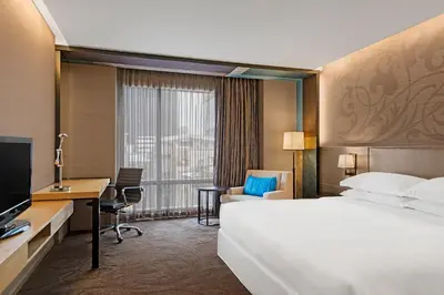 a hotel room with a bed and a desk at Paradox Bangkok Sukhumvit in Bangkok