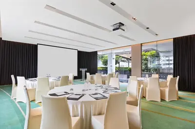 a conference room with a table and white chairs at Paradox Bangkok Sukhumvit in Bangkok