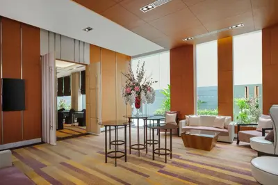 a hotel lobby with a table and chairs at Paradox Bangkok Sukhumvit in Bangkok