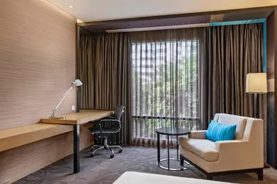 a hotel room with a desk and a chair at Paradox Bangkok Sukhumvit in Bangkok