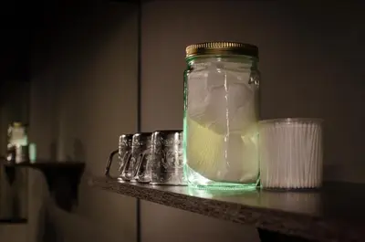 a glass jar with a lemon in it sitting on a counter at Tian Tian Hostel in Bangkok