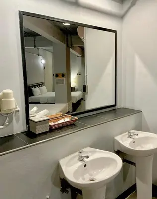 a bathroom with a sink and a mirror at Rest24 Residence in Bangkok