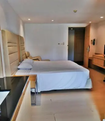 a bedroom with a large white bed in a room at The Tivoli Hotel in Bangkok