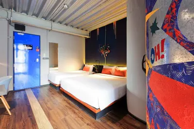 a bedroom with two beds in a room at MeStyle Garage Hotel in Bangkok