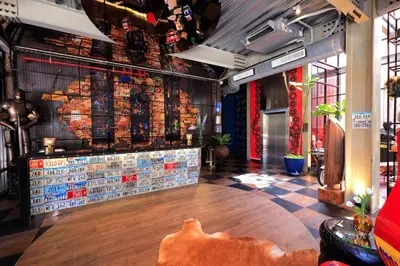 a restaurant with a counter with signs on the wall at MeStyle Garage Hotel in Bangkok