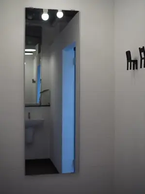 a bathroom with a mirror and a sink at Bangkok Sanookdee Hostel in Bangkok