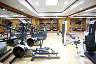 a gym with treadmills and elliptical machines at PJ Watergate Hotel in Bangkok