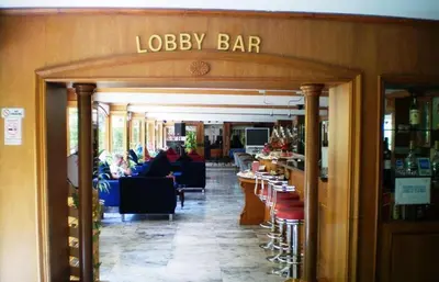 a lobby of a restaurant with people sitting at tables at PJ Watergate Hotel in Bangkok