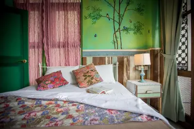 a bed with two pillows and a book on it at Phranakorn-Nornlen in Bangkok