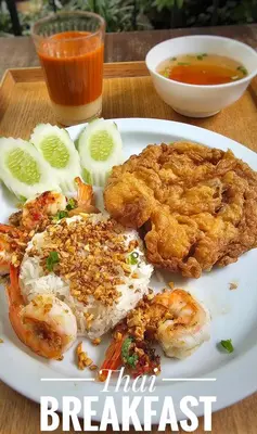 a plate of food with meat and a bowl of soup at Phranakorn-Nornlen in Bangkok