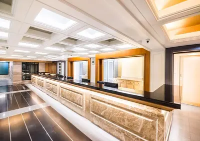 a long bar in a large room with windows at D&D Inn Khaosan in Bangkok