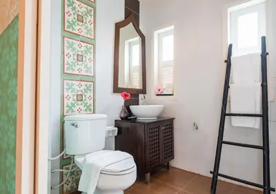 a bathroom with a toilet and a sink and a mirror at D&D Inn Khaosan in Bangkok