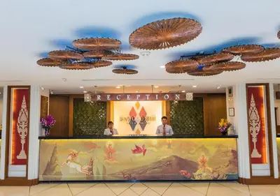 two people standing at the counter of a hotel at Dang Derm Khaosan in Bangkok