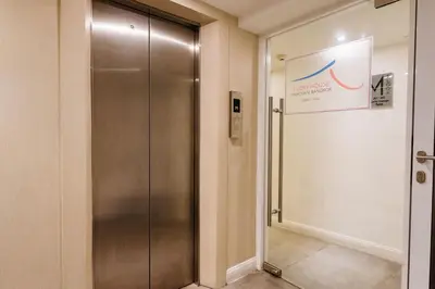 a elevator in a building with a sign on the wall at Lucky House Khaosan in Bangkok