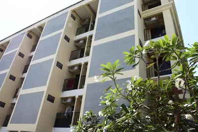 an apartment building with trees in front of it at The European Place in Bangkok