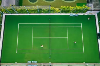 an overhead view of a tennis court with two people on it at Grande Centre Point Hotel Terminal21 in Bangkok